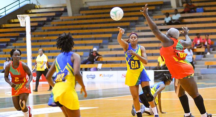 SVG goal attack makes a pass to SVG captain and wing attack Ruthann Williams against Grenada