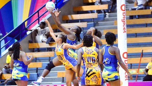 SVG goal shoot Mary-Ann Frederick under pressure by the Barbadian defence collects a pass.