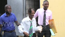 Detectives Constables PC 968 Soleyn, left, and 446 Hope escort the accused, Glenroy Primus to court on Wednesday, Nov. 23, 2022.