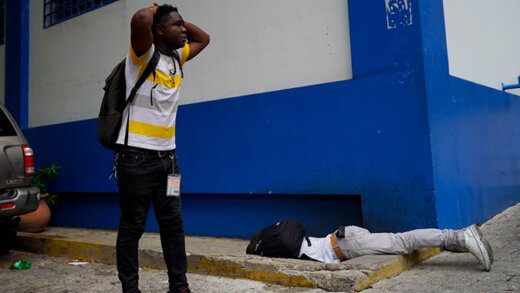 Haitian journalist Romélson Vilcin, who was fatally wounded lies face down inside the parking lot of a police station, in Port-au-Prince, Haiti, Sunday, Oct. 30, 2022. Vilsaint died Sunday after being shot in the head when police opened fire on reporters demanding the release of one of their colleagues who was detained while covering a protest, witnesses told The Associated Press. (AP Photo) (Uncredited/AP)