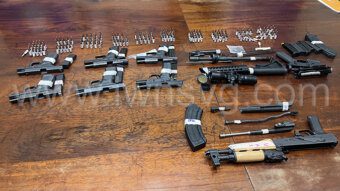 Unlicensed firearms and ammunition on display at a police press conference in Kingstown on Dec. 16, 2022.