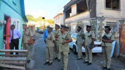 Commissioner of Police Colin John and other senior police officer interact with people in Paul's Avenue on Tuesday.