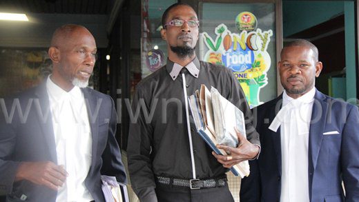 Danneke Billingy, centre, who spent seven years in prison, and his lawyers, Jomo Thomas, left, and Noel Bruce, right, after Billingy was freed on March 10, 2023.