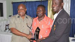 Commissioner of Police Collin John, left, and Head of the Traffic Branch, Parnel Browne, presents the award to retiring head of the Traffic Branch, Superintendent of Police Kenneth John at the event at Traffic Branch on March 24, 2023.  