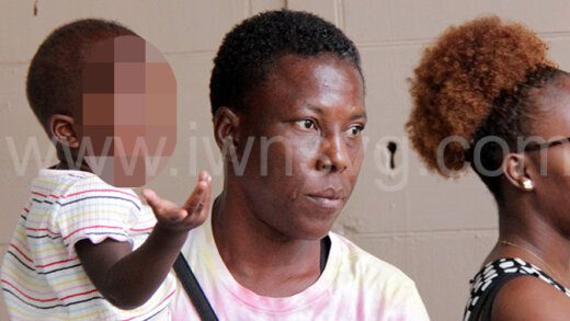 The defendant, Margaret Smith, holds her youngest child outside High Court No. 1, in Kingstown, on May 22, 2023, one of the days on which her sentencing was scheduled to take place.