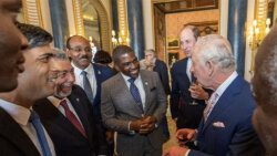 King Charles III, second from right, chats with prime ministers of nations of which he is head of state. From left: Dickon Mitchell of Grenada, Rishi Sunak of the UK, Ralph Gonsalves of St. Vincent and the Grenadines, Gaston Browne of Antigua and Barbuda, Terrance Drew of St. Kitts and Nevis and Prince William. (Photo: Searchlight.vc)