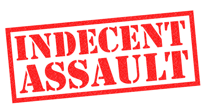 INDECENT ASSAULT red Rubber Stamp over a white background.