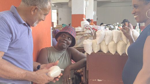 Opposition Leader Godwin Friday interacts with people at the Central Market in Kingstown. 