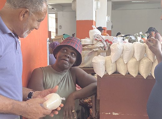 Opposition Leader Godwin Friday interacts with people at the Central Market in Kingstown. 