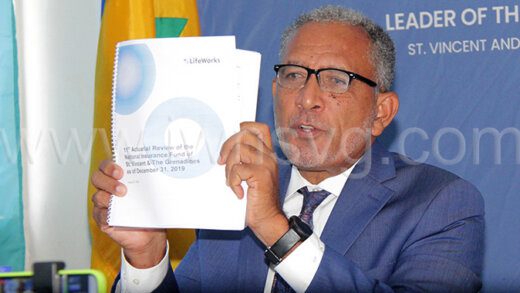 Opposition Leader Godwin Friday holds up a copy of the 11th actuarial review of the National Insurance Fund at a press conference in Kingstown on Wednesday, July 26, 2023. 