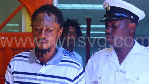 Roneake Burke leaves the Georgetown Magistrate’s Court in police custody on July 17, 2023 after failing to secure a surety. 
