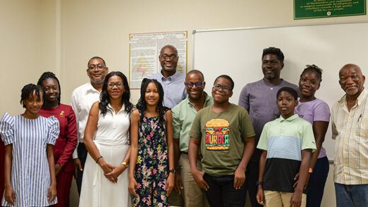 VINLEC CEO, Vaughn Lewis, centre rear, alongside 2023 VINLEC Scholarship recipients: Kezanni Wilkinson, left, Azizah Jack (fifth from left), Kyle Robinson, fifth from right, and Tyler Sterling, third from right, in the company of parents and NWM General Secretary, Noel Jackson, right.

