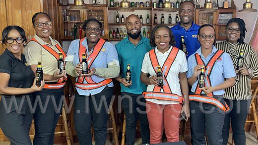 Country Manager of St. Vincent Brewery Ltd. Shafia London (fifth from left) and members of her team pose with bottles of the best Guinness in the Americas on Monday, Aug. 14, 2023.