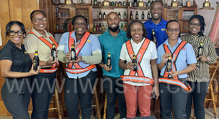 Country Manager of St. Vincent Brewery Ltd. Shafia London (fifth from left) and members of her team pose with bottles of the best Guinness in the Americas on Monday, Aug. 14, 2023.