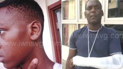 Damali Phillips, 13, left, show his face left swollen after a Vincentian police officer pelted him with a bottle of body lotion at a camp in St. Lucia and his father Dwight Phillips with a an arm he alleged a police officer broke in Kingstown in 2017. 