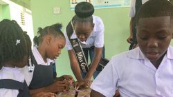 Miss SVG contestants and students of the Barrouallie Government School participating in craft activities.