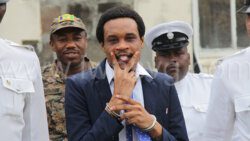 Devon “Chiefman” Charles gestures as he is led back to prison on Oct. 3, 2023 after being found guilty of a firearm charge  and not guilty of the related murder charge.