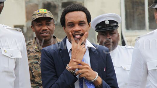 Devon “Chiefman” Charles gestures as he is led back to prison on Oct. 3, 2023 after being found guilty of a firearm charge  and not guilty of the related murder charge.