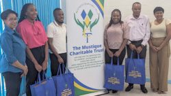Four (bursary awardees for 2023 with UWIGC Officer-in-Charge, left, and MCT Administration Director,right.jpg