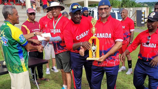 Acting Manager of the SVG Sports Council, Julian Burgin presents the second place prize in the over 50 division to Canada Masters, which should not have been in the finals of the competition at Sion Hill on Nov. 4, 2023.