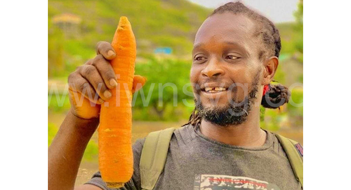 Farmer Jimodean “Jim” Sam was gunned down in Layou on Thursday, Nov. 23, 2023 while walking along a mountain road. He is seen here in an undated social media photo showing off one of his carrots.