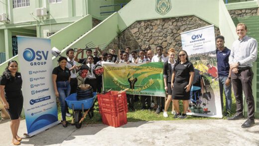 Representatives from OSV and ZHTF pose with students of the St. Vincent Grammar School with some of the items that were donated.