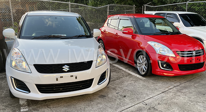 The two Suzuki Swift cars that Digicel is giving away during its Christmas promotion.