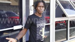 Michael Olan Lyscott gestures in objection to being photographed outside the Kingstown Magistrate's Court after a scheduled court appearance on Monday, Dec. 4, 2023. 