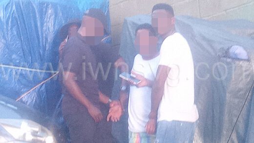 Uniformed and a plainclothes police officers, restrain the man, third left, after the incident on Villa Beach on Wednesday, Dec. 6, 2023. 