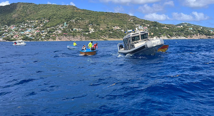 Local fishermen and divers along with a Coast Guard interceptor at the site of the plane crash off Bequia on Thursday, Jan. 4, 2024.