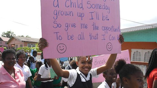 A student displays a placard during the march and rally in Georgetown on Friday, Jan. 26, 2024.