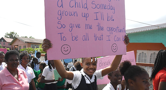 A student displays a placard during the march and rally in Georgetown on Friday, Jan. 26, 2024.