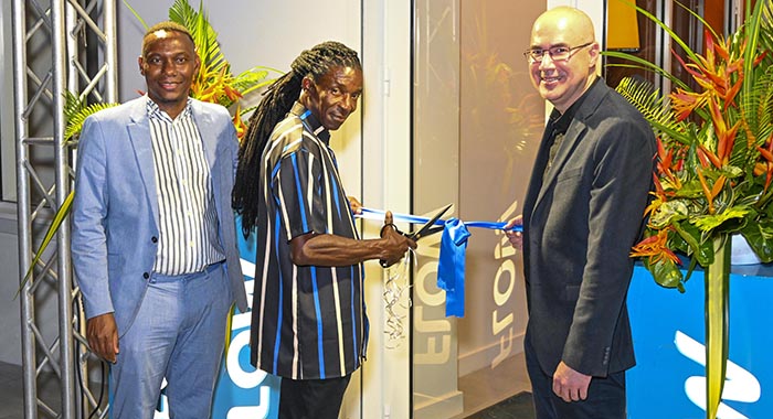 The ribbon cutting to the newly refurbished Flow office in Arnos Vale. From left: Wayne Hull, country manager Flow St. Vincent; Leroy Isaacs, Flow technician;  Waldo Hooker,  vice president, South Caribbean, C&W Communications. 