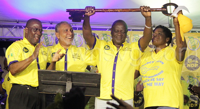Andrew John holds up a key, the symbol of the New Democratic Party, while surrounded by (from left) former candidate, Noel Dickson, NDP Leader Godwin Friday, and John’s wife, Cheryl John, at his launch in Biabou, on Saturday, March 9, 2024.