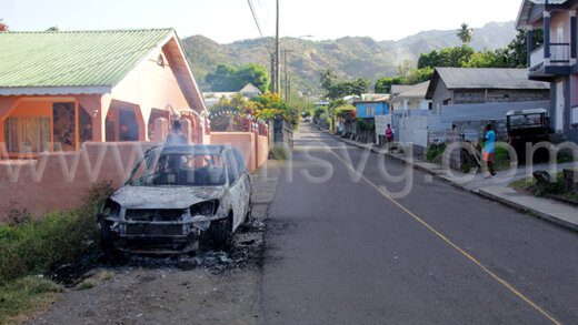 Smoke rises from the burnt-out shell of Desley Gaymes' car hours after it was destroyed by fire in Layou on March 21, 2024. 