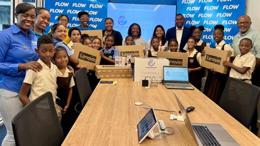 Teachers and students from the Dorsetshire Hill and Sion Hill Government schools receive their donations from Flow.