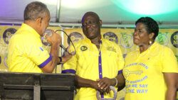 Opposition Leader and NDP President, Godwin Friday, left, speaks with the party candidate Andrew John and his wife, Cheryl John, at John’s launch as the party’s candidate for South Windward in Biabou on Saturday, March 9, 2024.