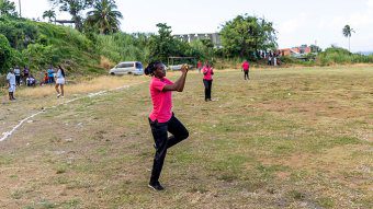 A  Passionate Girls cricketer taking a catch.