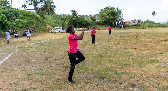 A  Passionate Girls cricketer taking a catch.