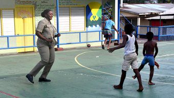 Superintendent of Police Kamecia Blake plays a game with children in South Rivers on Thursday, April 18, 2024.