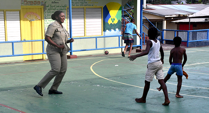Superintendent of Police Kamecia Blake plays a game with children in South Rivers on Thursday, April 18, 2024.
