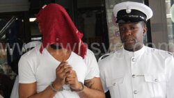 A police officer escorts the defendant, Bally Alexander back to prison on Friday, May 31, 2024. 