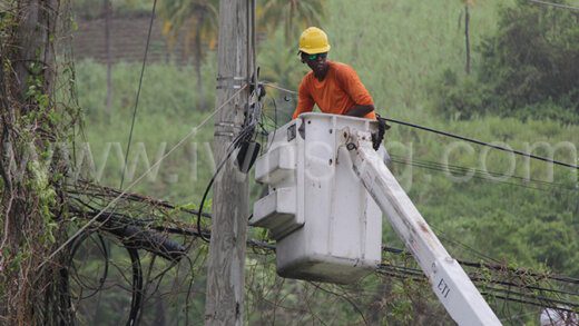 An electricity workers works to restore power in the Mt Young area on July 2, 2024, following the passage of Hurricane Beryl.