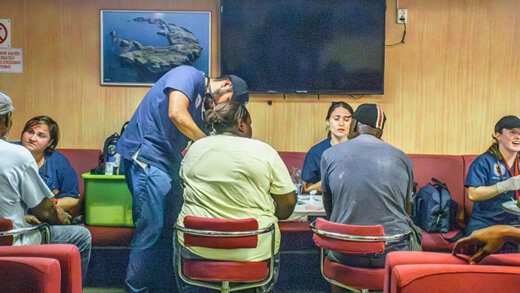 Medical students from Trinity Medical Sciences University attending to people before directing them to other specialists for further medical attention where necessary. 