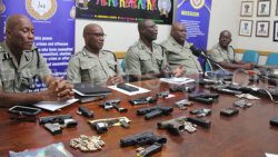 Member of the police high command showcase weapons and ammunition seized by or surrendered to police at a press conference in Kingstown on July 17, 2024.