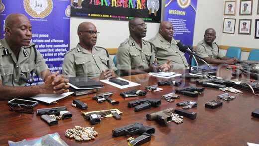 Member of the police high command showcase weapons and ammunition seized by or surrendered to police at a press conference in Kingstown on July 17, 2024.