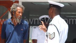 The defendant Randy Harry, left, speaks with a police officer outside the Colonarie Magistrate on Thursday, July 25, 2024.