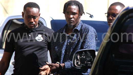 Police escort murder accused, Douglas Baptiste, centre, to the Serious Offences Court in Kingstown on Thursday, Aug. 22, 2024.