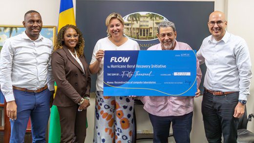 Inge Smidts, CEO of C&W Communications, presents a grant of $US50,000 to  Ralph Gonsalves, prime minister of St. Vincent and the Grenadines. They are joined by (from left) Wayne Hull, country manager, Flow St Vincent; Marilyn Sealy, senior director, head of communications, C&W Communications; and Waldo Hooker, vice vresident, South Caribbean, Flow.