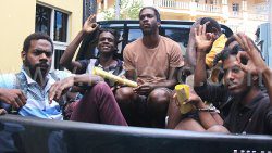 The four Trinidadians and one Vincentian in a police pick-up outside the Serious Offences Court on Monday, Oct. 7, 2024.